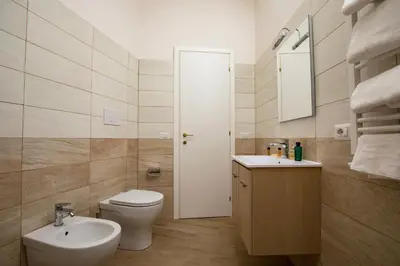 a bathroom with a white toilet and a sink at Your Secret Pantheon in Rome
