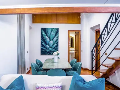 a living room with a table and a mirror at Spanish Steps Terrace Loft IREX Apartment in Rome