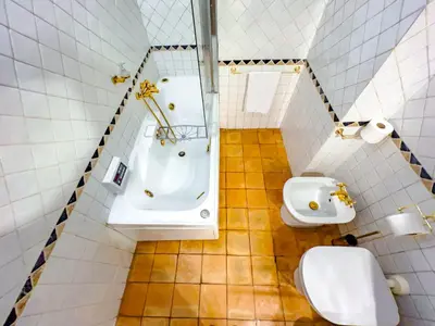 a bathroom with a toilet and a sink and a tub at Spanish Steps Terrace Loft IREX Apartment in Rome