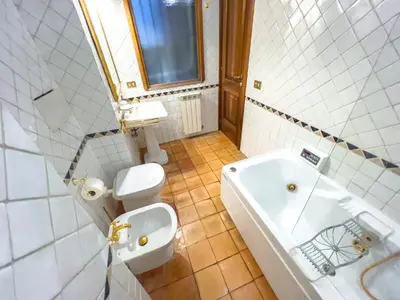 a kitchen with wooden cabinets and a stove at Spanish Steps Terrace Loft IREX Apartment in Rome