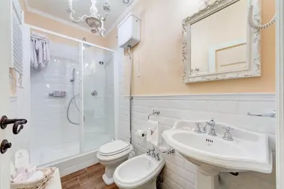 a bathroom with a sink and a toilet and a shower at Lunaria Suites Rome Vaticano in Rome