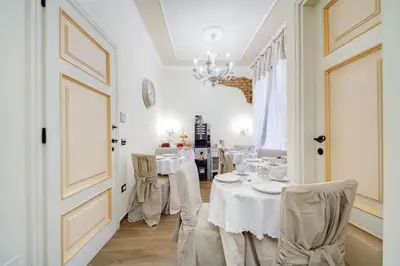 a dining room with white tables and chairs at Lunaria Suites Rome Vaticano in Rome
