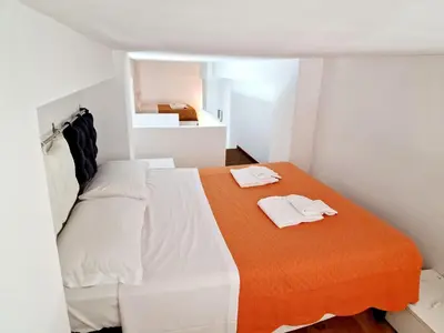 a bedroom with a bed with two towels on it at Lofts In Rome in Rome