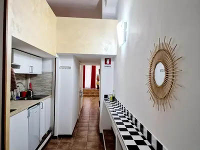 a kitchen with a black and white checkered floor at Lofts In Rome in Rome