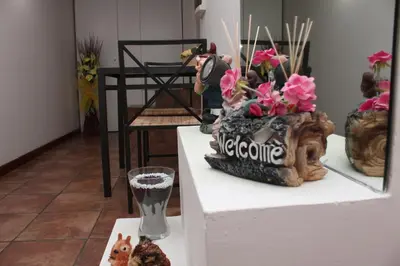 a table with vases and flowers on top of it at Lofts In Rome in Rome
