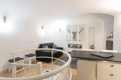 a white living room with a table and chairs at Vicolo Navona in Rome