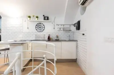 a kitchen with white walls and a counter top at Vicolo Navona in Rome