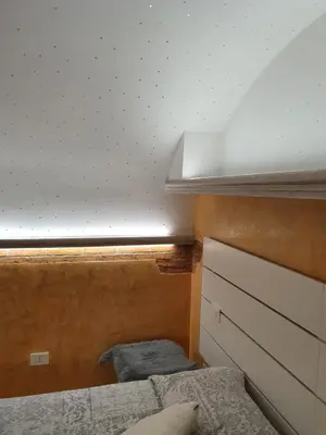 a bedroom with two beds and a white ceiling at Vicolo Navona in Rome