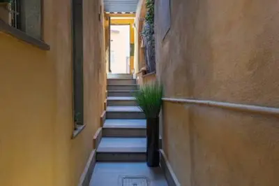 a hallway with stairs with a plant in a vase at Vicolo Navona in Rome