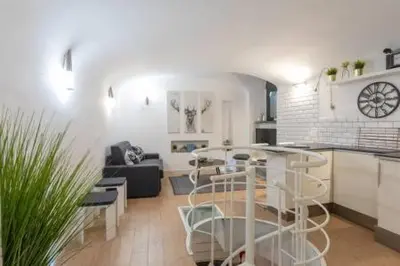 a kitchen and living room with a table in a room at Vicolo Navona in Rome