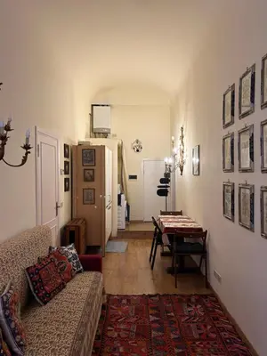 a living room with a couch and a table and a refrigerator at Stylish apartment in central Rome 