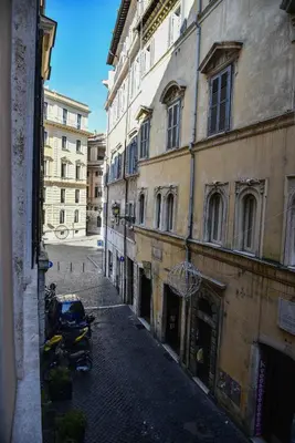 an empty street in an alley between two buildings at Stylish apartment in central Rome 