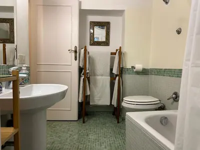 a bathroom with a sink and a toilet and a tub at Stylish apartment in central Rome 