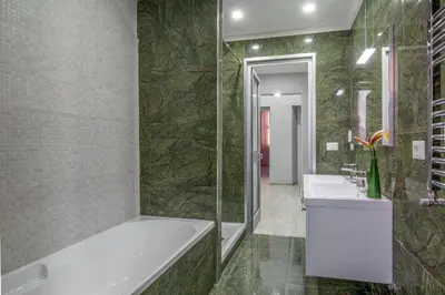 a bathroom with a tub and two sinks and a shower at Well Done Montebello in Rome