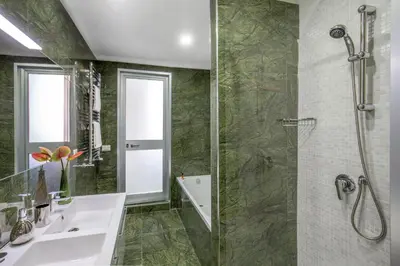 a bathroom with a shower and a sink and a mirror at Well Done Montebello in Rome