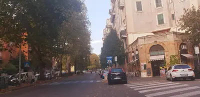 a yellow column next to a building with a statue on it at B&B Lumiere Roma in Rome