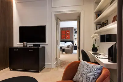 a living room with a television and a couch at The First Dolce - Preferred Hotels & Resorts in Rome