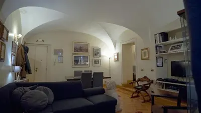 a living room with a couch and a table and a tv at MGPGroup Guest House Navona in Rome