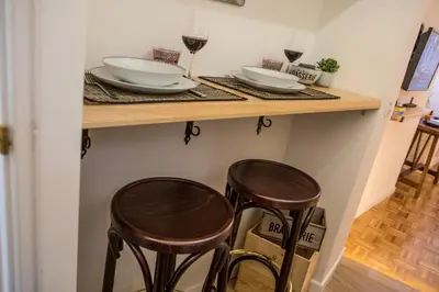 a shelf with plates and wine glasses and two stools at Amazing Trevi Fountain in Rome