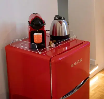 a red refrigerator with a tea kettle on top of it at Amazing Trevi Fountain in Rome