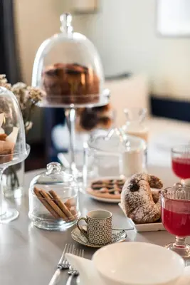 a table with plates of pastries and glasses of wine at Teichnersuite in Rome