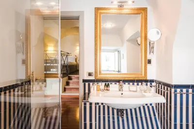 a bathroom with a sink and a mirror at Teichnersuite in Rome