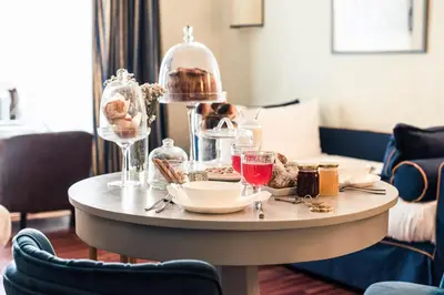 a table with plates and glasses on top of it at Teichnersuite in Rome