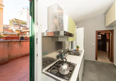 a kitchen with a stove with a tea kettle on it at CasaJusta Trastevere in Rome