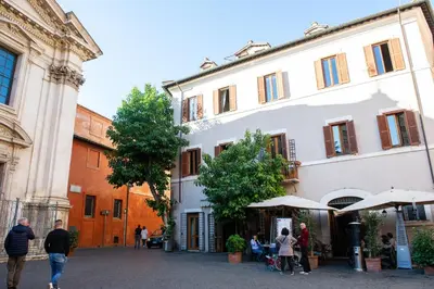 a group of people walking in a street next to a building at CasaJusta Trastevere in Rome