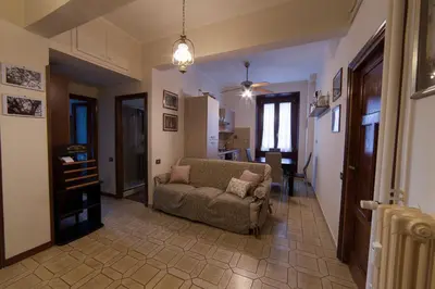 a living room with a couch and a kitchen at Piazza Bologna in Rome