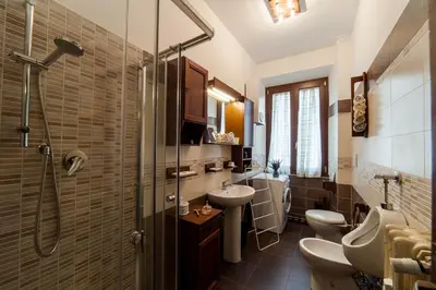 a bathroom with two toilets and a sink and a shower at Piazza Bologna in Rome