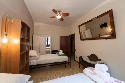 a bedroom with two beds and a mirror on the wall at Piazza Bologna in Rome