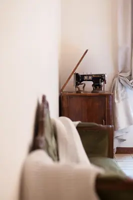 a living room with a sewing machine and a couch at Piazza Bologna in Rome