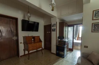 a living room with a couch and a tv on the wall at Piazza Bologna in Rome