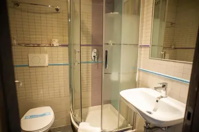 a bathroom with a shower and a sink and a toilet at Gracchi Guest House in Rome