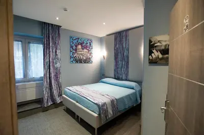a small bedroom with a bed and a window at Gracchi Guest House in Rome