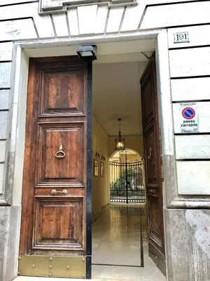 an entrance to a building with a large wooden door at Gracchi Guest House in Rome