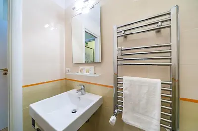 a bathroom with a white sink and a mirror at Nostalgia Romana in Rome