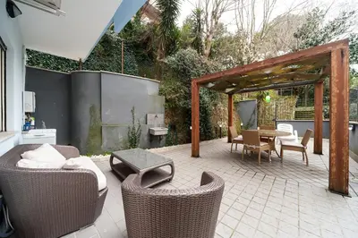 a patio with wicker chairs and a table at Nostalgia Romana in Rome