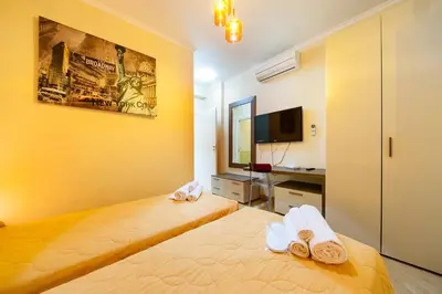 a hotel room with a bed and a tv at Nostalgia Romana in Rome