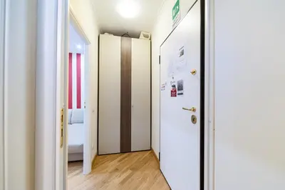 a hallway with a door leading to a bedroom at Nostalgia Romana in Rome