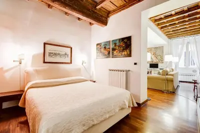 a bedroom with a bed and a living room at Diana-Spanish Steps House in Rome