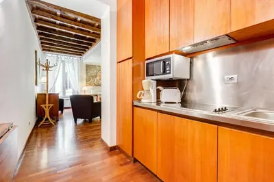 a kitchen with a sink and a microwave at Diana-Spanish Steps House in Rome