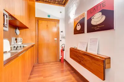 a hallway with a door leading to a kitchen at Diana-Spanish Steps House in Rome