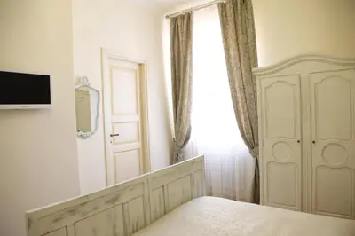 a bedroom with a bed and a window and a door at Bed and Breakfast 30 in Rome