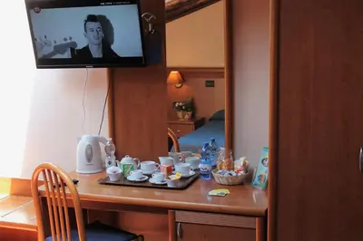 a room with a table with cups and a television at Nights In Rome in Rome