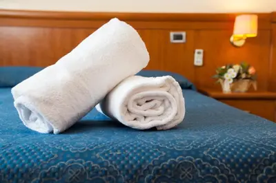 a rolled up towel sitting on top of a bed at Nights In Rome in Rome