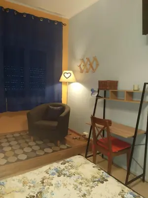 a living room with a chair and a table and a chair at roma capoccia b&b in Rome