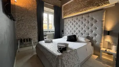 a bedroom with a large bed with a large headboard at Rhome Luxury suite in Rome