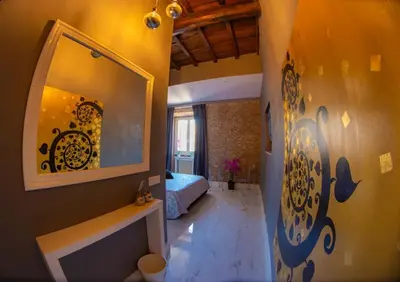 a bedroom with a bed and a mirror on the wall at Rhome Luxury suite in Rome